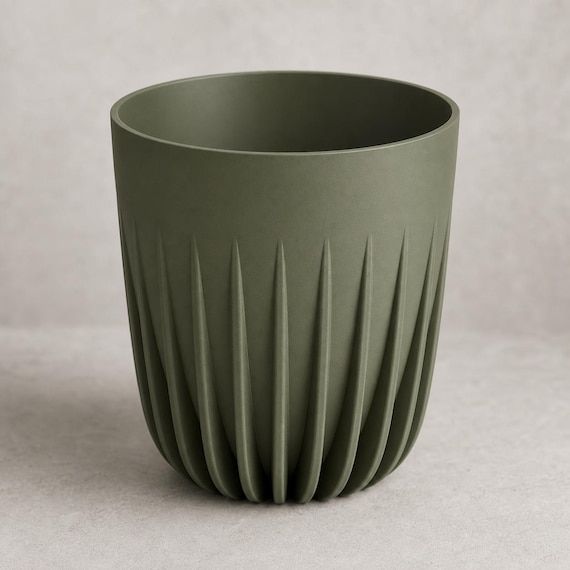 Elevated close-up of an empty medium CrownRill architectural rib planter in Dark Green