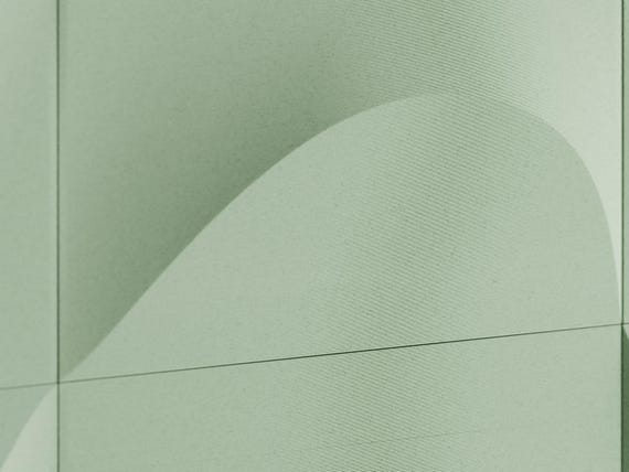 Macro close-up of the green TideFold relief surface and curved dimensional profile