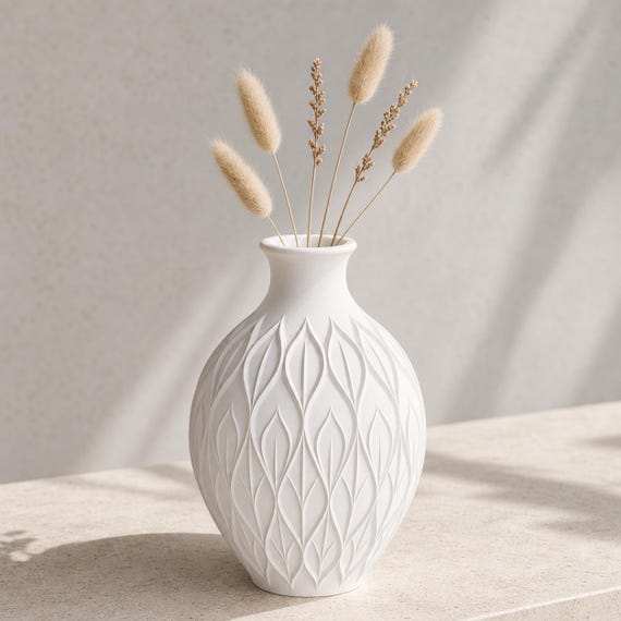 Close-up of the White CanopyMuse sculptural vase with a sparse dried botanical arrangement