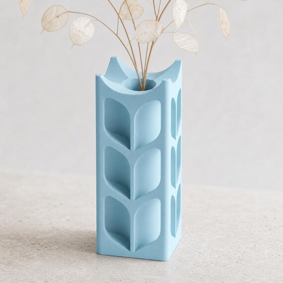 Close-up of the ArborLume botanical window vase in Ice Blue with pale lunaria stems
