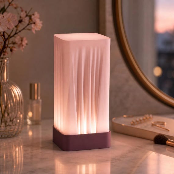 Sakura Dusk Woven Glow vanity lamp with Plum base and Sakura Pink closed-top shade
