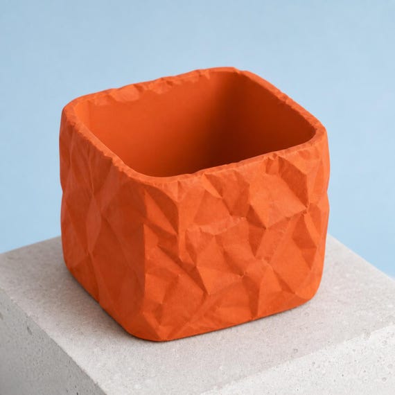 Empty square crumpled paper look planter in Terracotta showing the rounded square opening