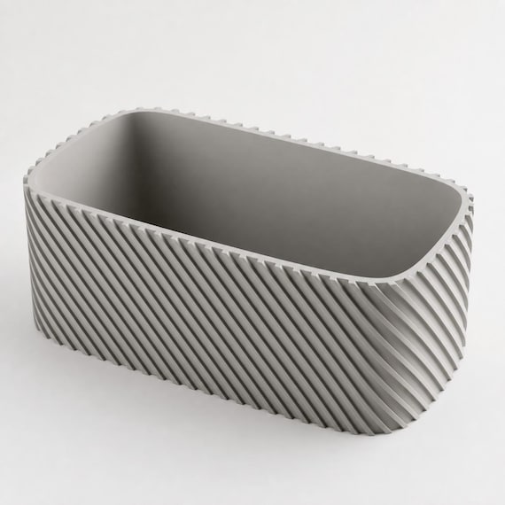 Ash Gray Driftline planter showing the diagonal ribs, rounded corner, rim, and interior