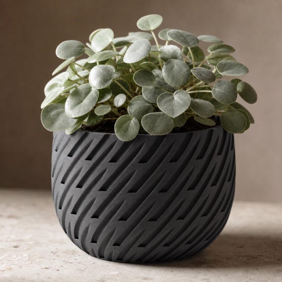 Close-up of the Charcoal Leafstream planter emphasizing its continuous diagonal lattice