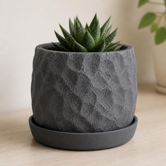 Close-up of the complete Riftstone rock texture planter seated in its matching drainage tray