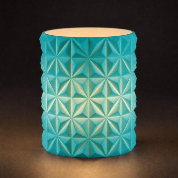 Close-up of the PrismGlow geometric LED tealight sleeve in Turquoise