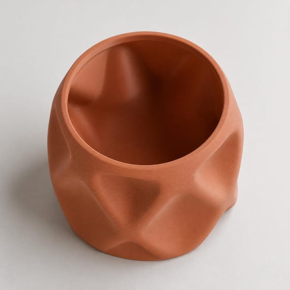 Elevated close-up of the empty PillowFacet planter opening and smooth interior in Terracotta