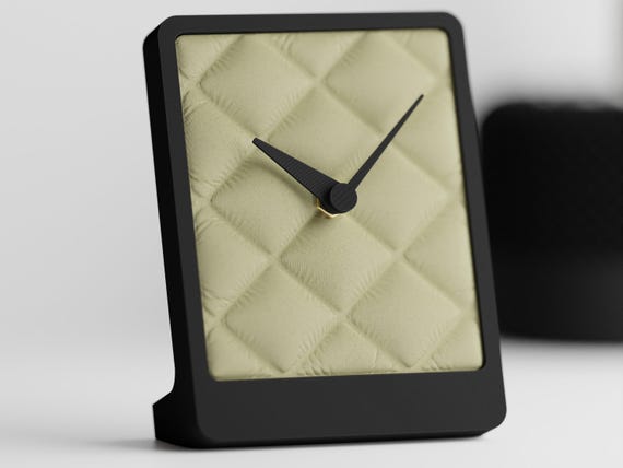 Alternate close-up of the Quiltmere table clock's angled sculptural profile