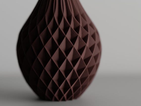 Angled close-up of the PrismWeave geometric vase cross-spiral texture
