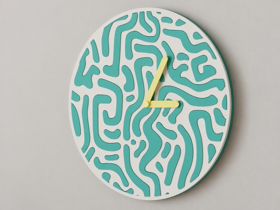 Flowmaze Wall Clock, turquoise and white organic pattern with yellow hands, close-up on a gray wall from the source photograph viewpoint.