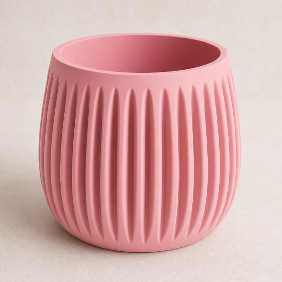 Elevated close-up of the empty GrooveNest planter in Sakura Pink showing its smooth rim and deep interior