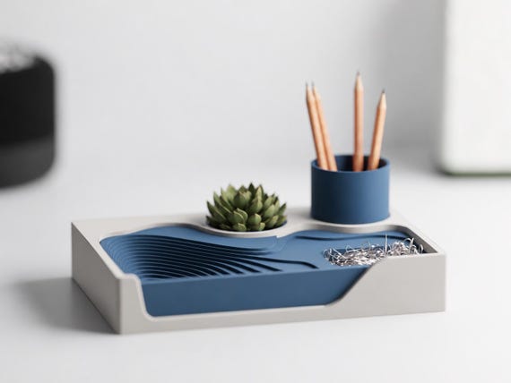 TerraceHub organizer with Ivory White outer frame and Dark Blue landscape and pen cup, front three-quarter desk view.