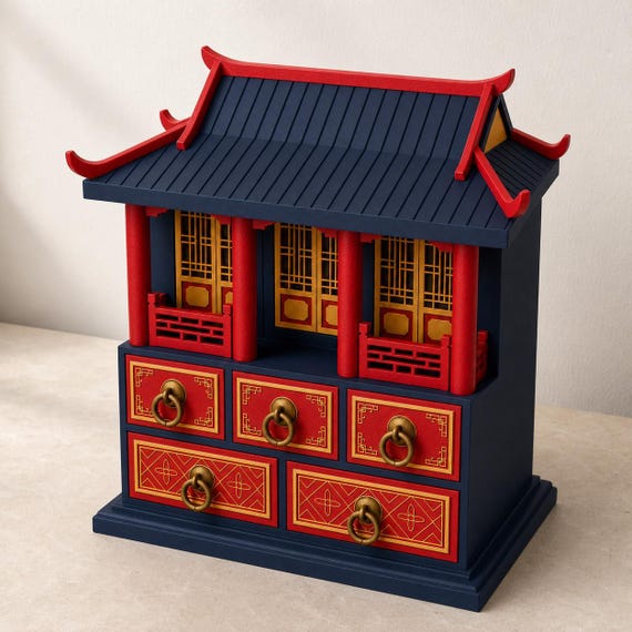 Palace Blue pavilion chest on a pale stone tabletop from a high left angle, showing the ribbed roof, upturned eaves, lattice panels, and five drawers