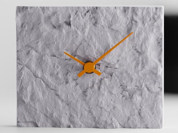 Straight-on close-up of the Stonewake sculptural table clock