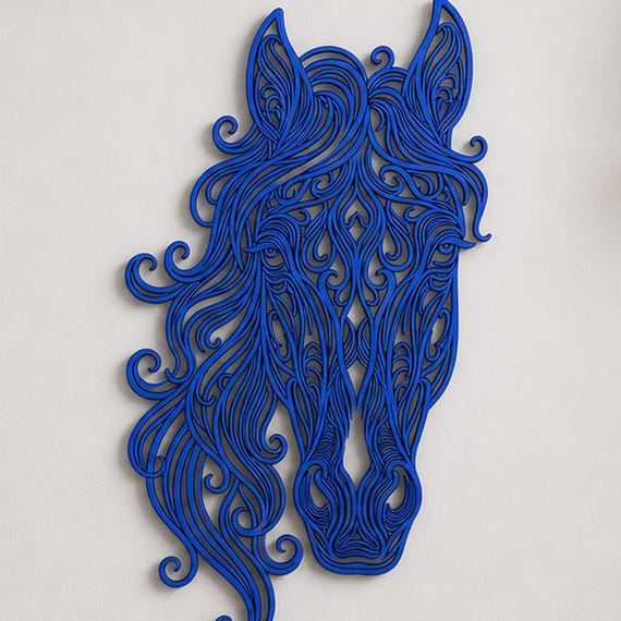Close-up of Flowing Horse Head filigree wall art in Cobalt Blue in a contrasting room