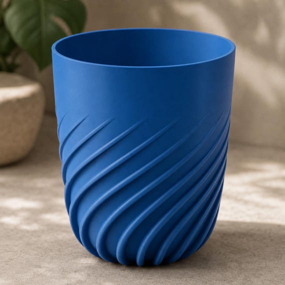 Close-up side view of an extra large Flowspire spiral rib planter in Marine Blue