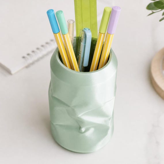 Elevated close-up of the CrinklePop pen cup in Silk Mint holding pencils pens and a ruler