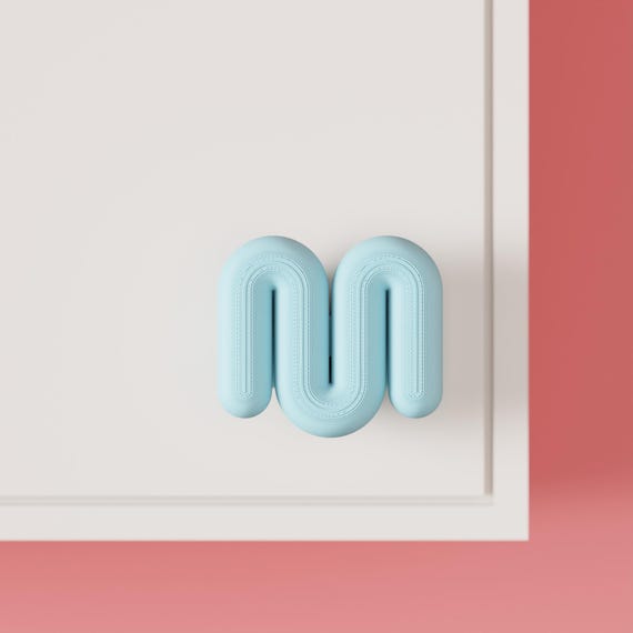 Light blue wavy cabinet knob on a white cabinet, front view.
