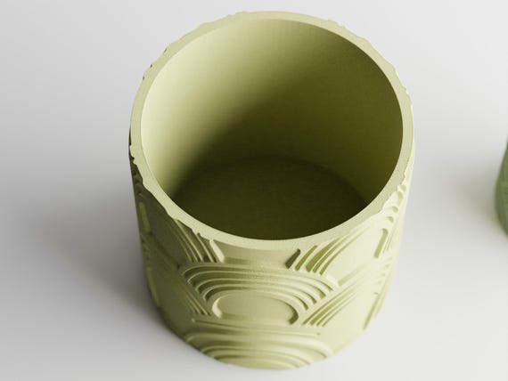 Elevated close-up of an empty recessed-pattern ArcEcho planter showing its circular opening