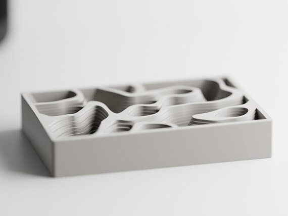 Front three-quarter view of the empty ContourCove sculptural desk and jewelry organizer