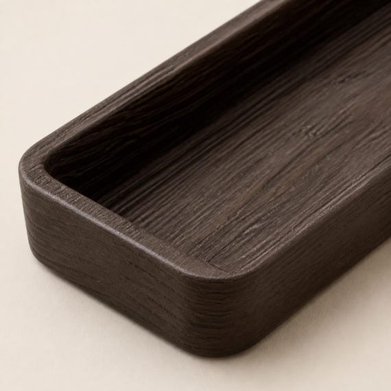 Close-up of the Timberfold tray's continuous tactile grain across the rim walls and basin