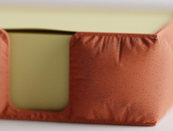 Close-up of the GatherPad holder's gathered fabric-look plastic surface