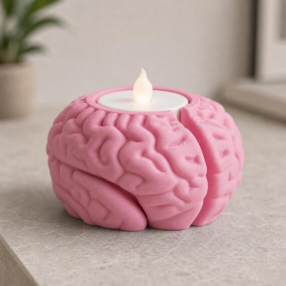 Sakura Pink CortexHalo brain-shaped flameless tealight holder on a modern console