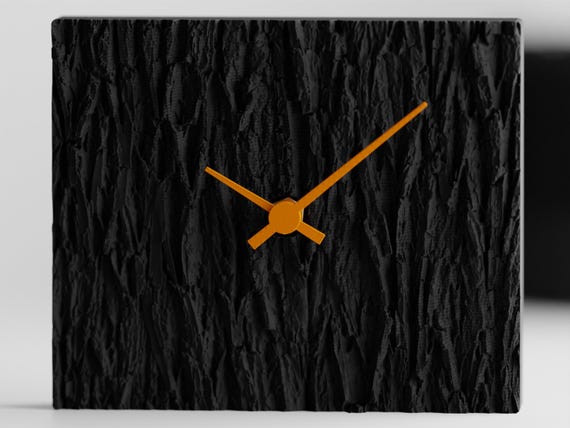Tree-bark textured table clock displayed on an office shelf