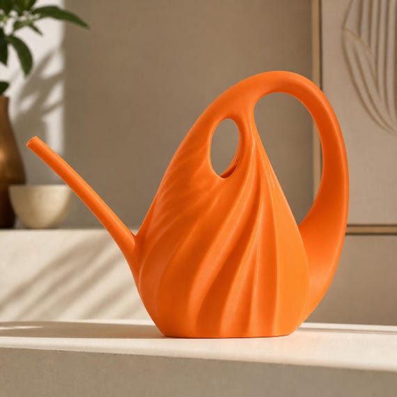Close side view of the standard TideArc watering can in Pumpkin Orange