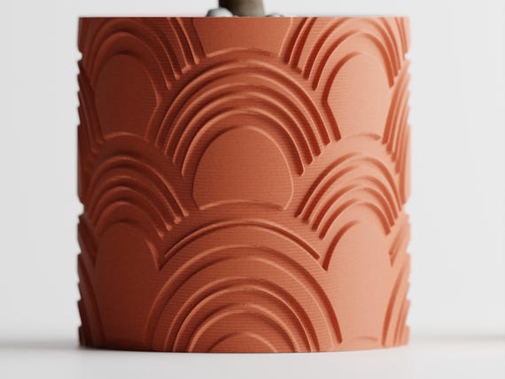 Straight-on close-up of the repeating raised arch pattern on an ArcEcho planter
