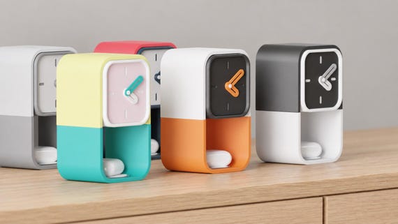 Pocketime Storage Desk Clock colorful examples from an angled source view on oak, with white earbud cases as styling accessories.