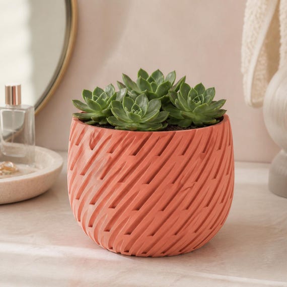 Close-up of the Sakura Pink Leafstream planter with a cluster of green succulent rosettes