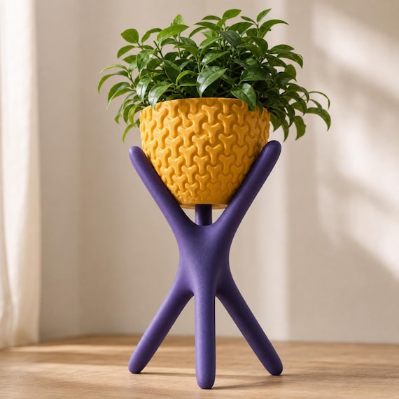 Close-up low angle of the Large AeroNest planter in Indigo Purple and Gold with a leafy plant