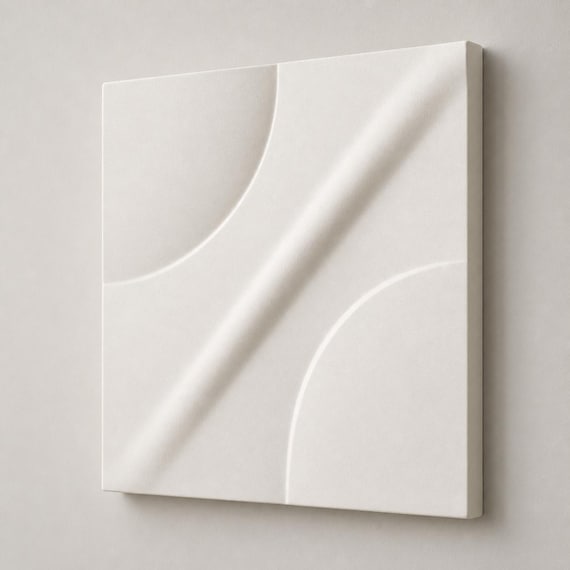 Right-angle close-up of the Ivory White OrbitArc relief tile showing its sculpted depth