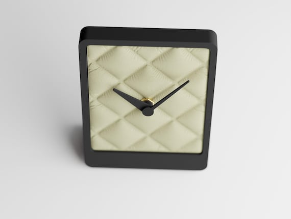 Front-angle close-up of the Quiltmere table clock and diamond-quilt face