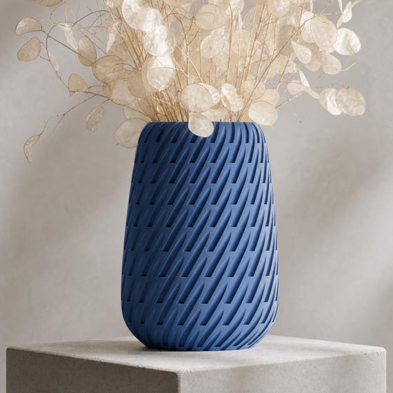 Close-up of the Marine Blue Leafstream sculptural vase with pale dried lunaria stems