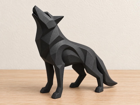 Charcoal wolf sculpture, close-up alternate camera angle on pale oak against an ivory wall.
