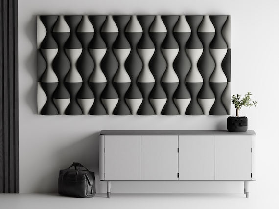 Close-up charcoal and ivory HaloWeave tile arrangement mounted above a modern console