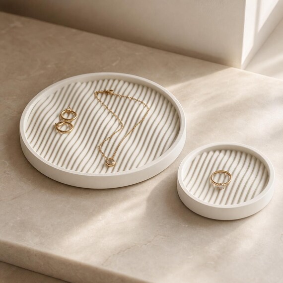 Ivory White Ripple Haven catchall trays holding rings and delicate jewelry on a vanity