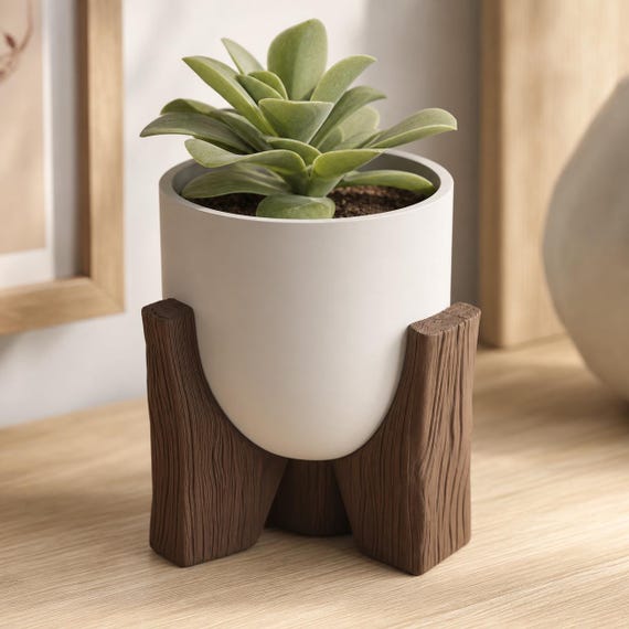 Side close-up of the smooth tripod planter with a compact succulent