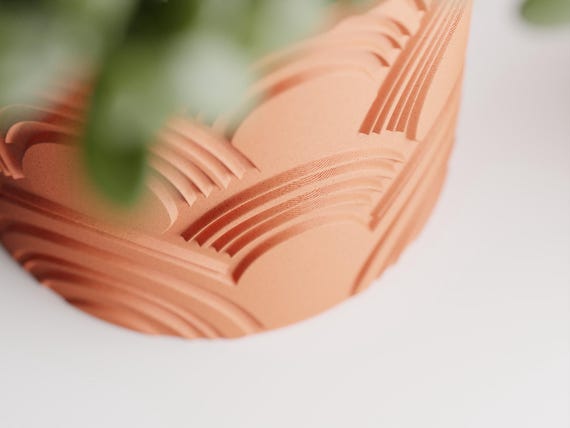 Macro detail of the raised fan-shaped ridges on an ArcEcho planter
