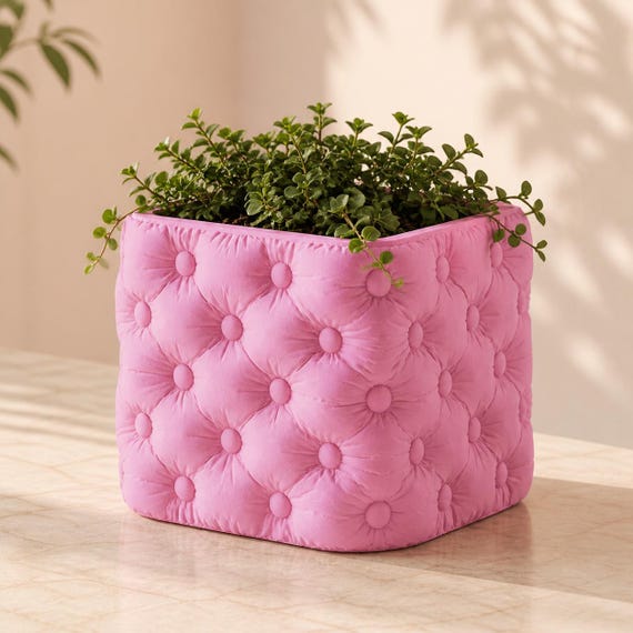 Cushioncrest decorative planter in Sakura Pink with trailing greenery