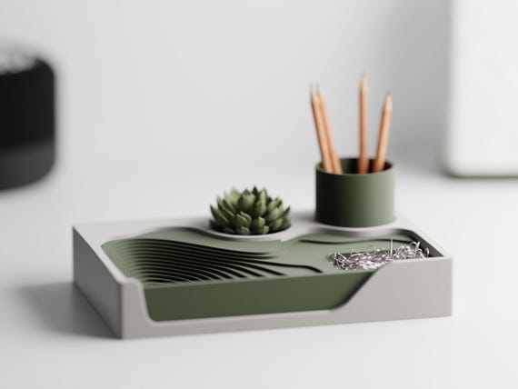 Topographic desk organizer with a catchall tray and pen cup on an office desk