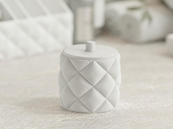 Close-up of the FacetCloud ivory quilted cotton-pad jar with a matching matte lid