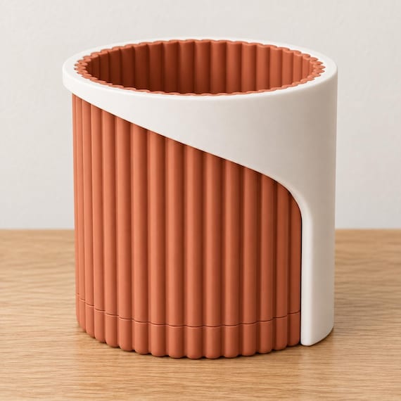 Elevated view of the Desert Clay Arvenna planter showing its Bone White wrap, Terracotta ribbed pot, open mouth and matching low drip tray.