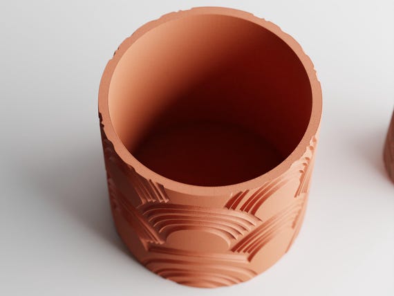 Elevated close-up of an empty raised-pattern ArcEcho planter showing its circular opening