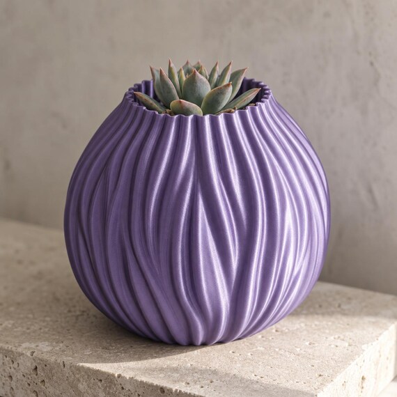 Close-up of the Tidegrove Round Vessel in lustrous Silk Purple with a small succulent