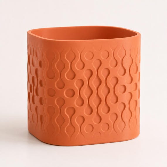 Close-up three-quarter view of the Tidecell rounded square planter in Terracotta