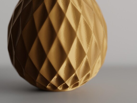 Extreme close-up of the LatticeGourd vase raised geometric relief and light-catching texture