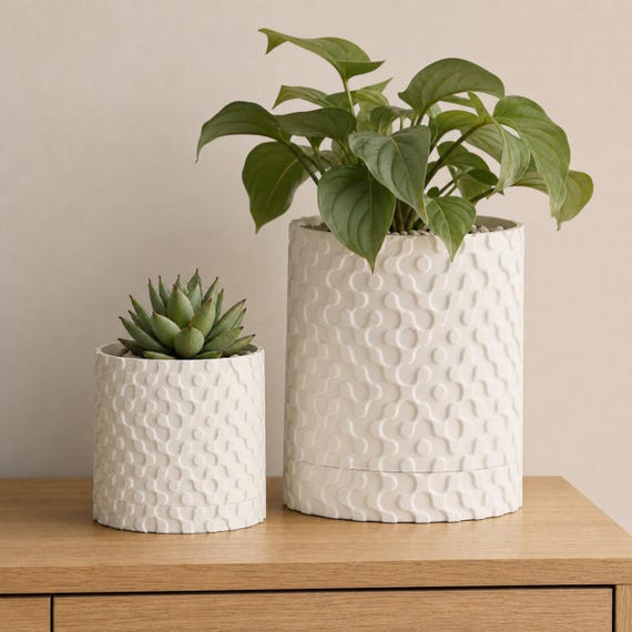 Medium and Large RippleGlyph planters in Ivory White with matching drip trays